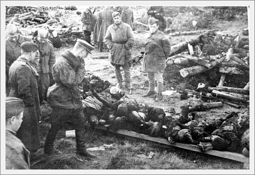 Soviet soldiers standing next to bodies to be burned at Klooga